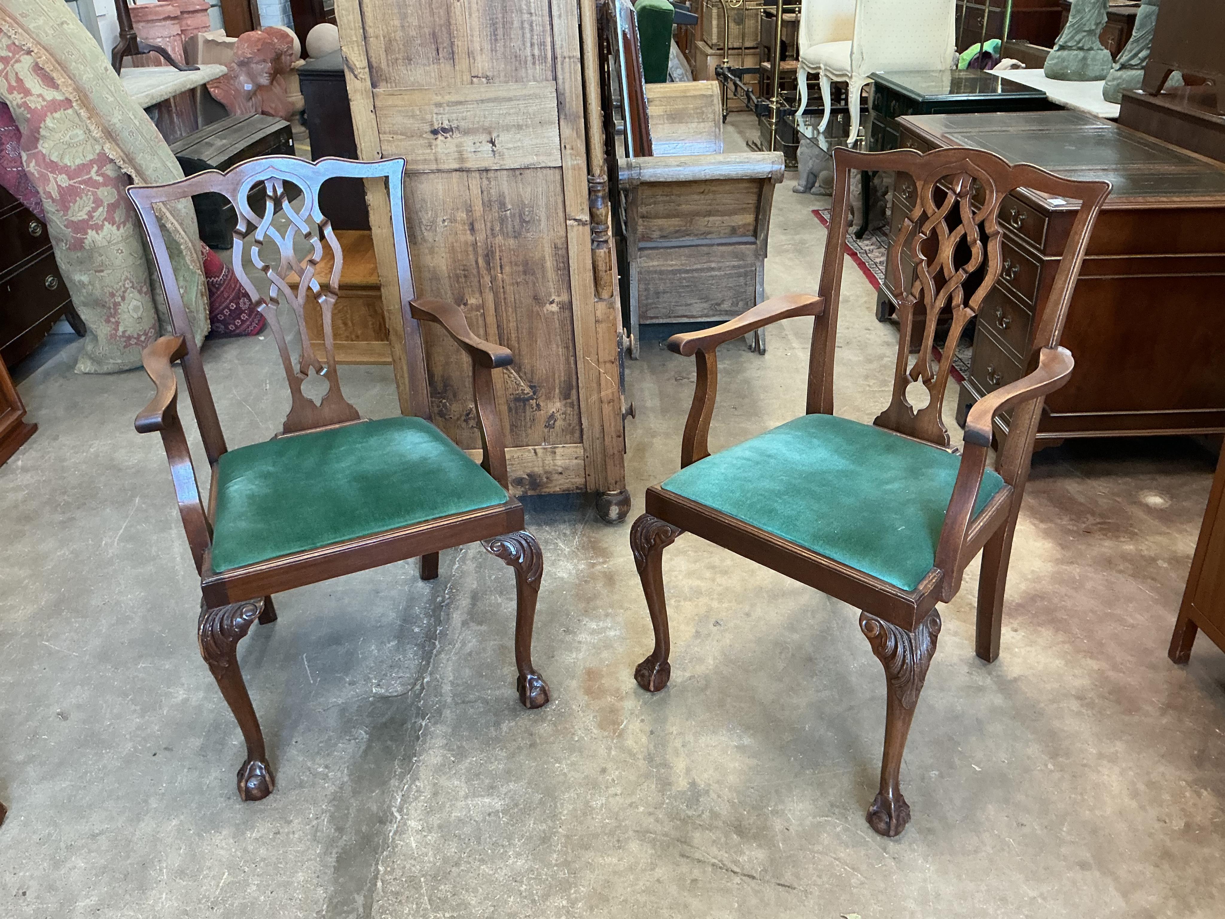 A Chippendale Revival mahogany extending dining table, 210cm extended, two spare leaves, depth 106cm, height 74cm together with a set of six Chippendale Revival mahogany dining chairs, two with arms